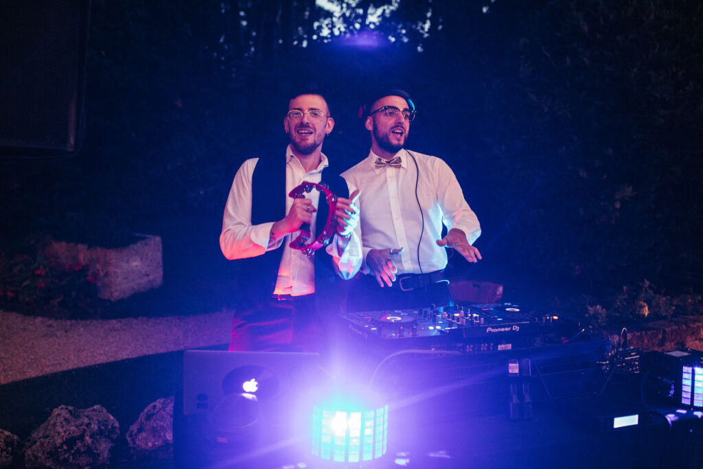 The DJs in action, setting the rhythm and creating an energetic atmosphere, adding beats to the joyous celebration of the bride and groom's special day