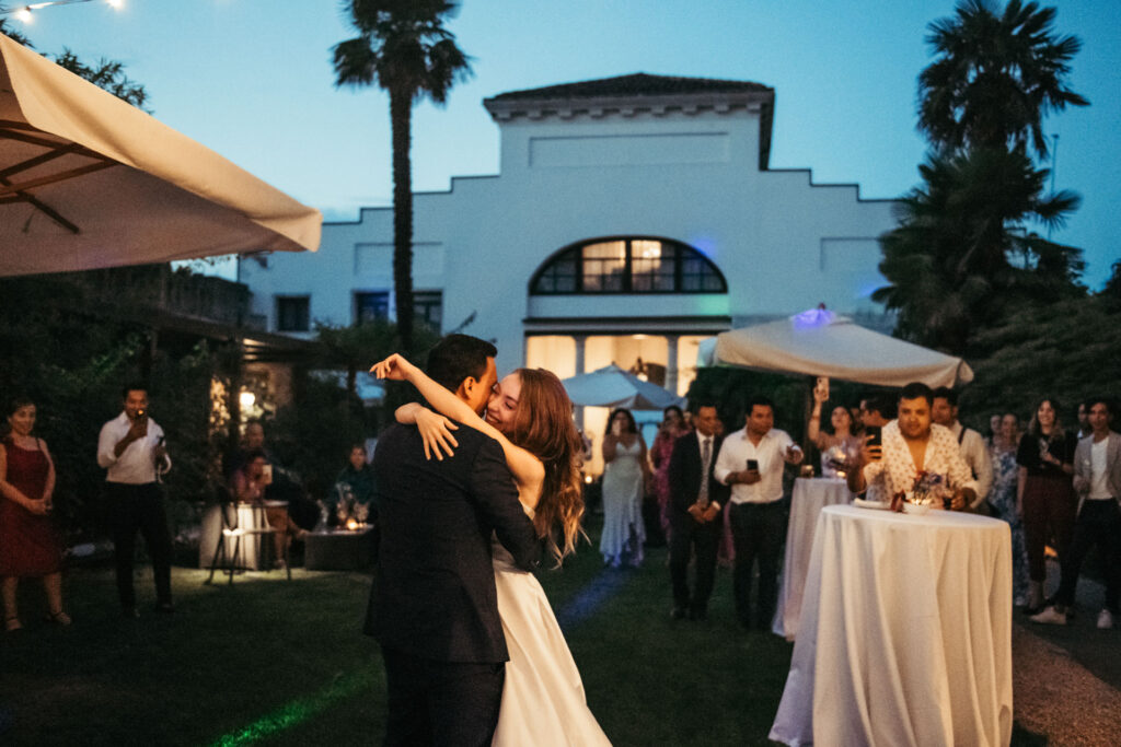 The bride and groom share a tender moment on the dance floor, their graceful movements capturing the magic of their first dance as a married couple