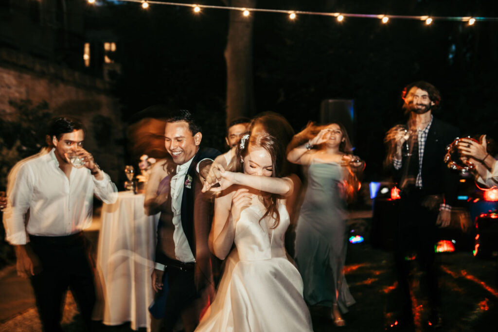 The dance floor comes alive with energy and joy as guests celebrate, creating a lively and festive atmosphere filled with laughter and movement