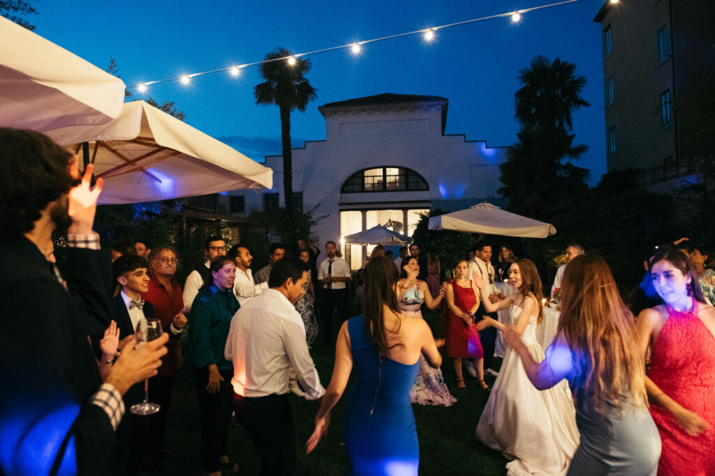 The dance floor comes alive with energy and joy as guests celebrate, creating a lively and festive atmosphere filled with laughter and movement