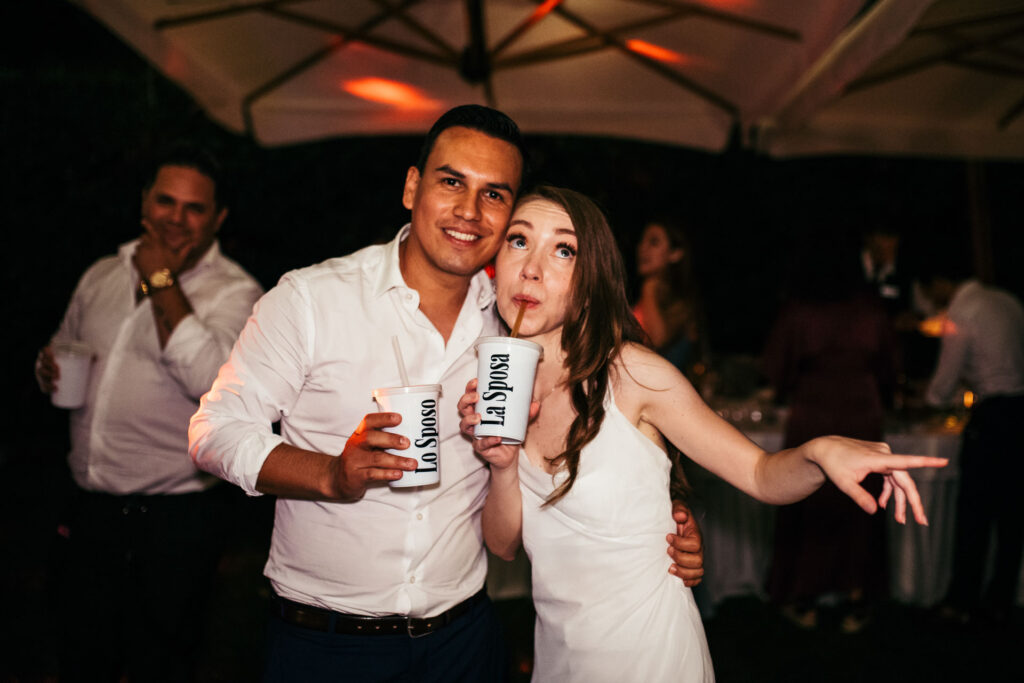 he bride and groom strike a pose while partying, showcasing their joy and flair as they dance and revel in the festivities