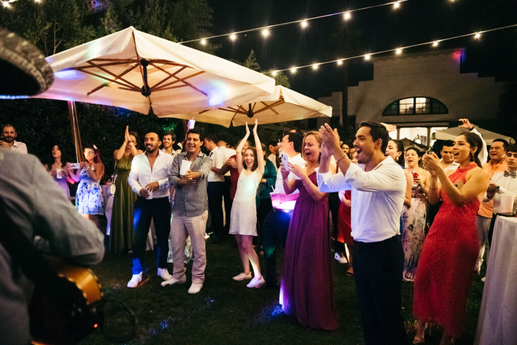 The crowd erupts in celebration as the Mariachi band plays, filling the air with lively and spirited music, adding a festive touch to the joyous occasion