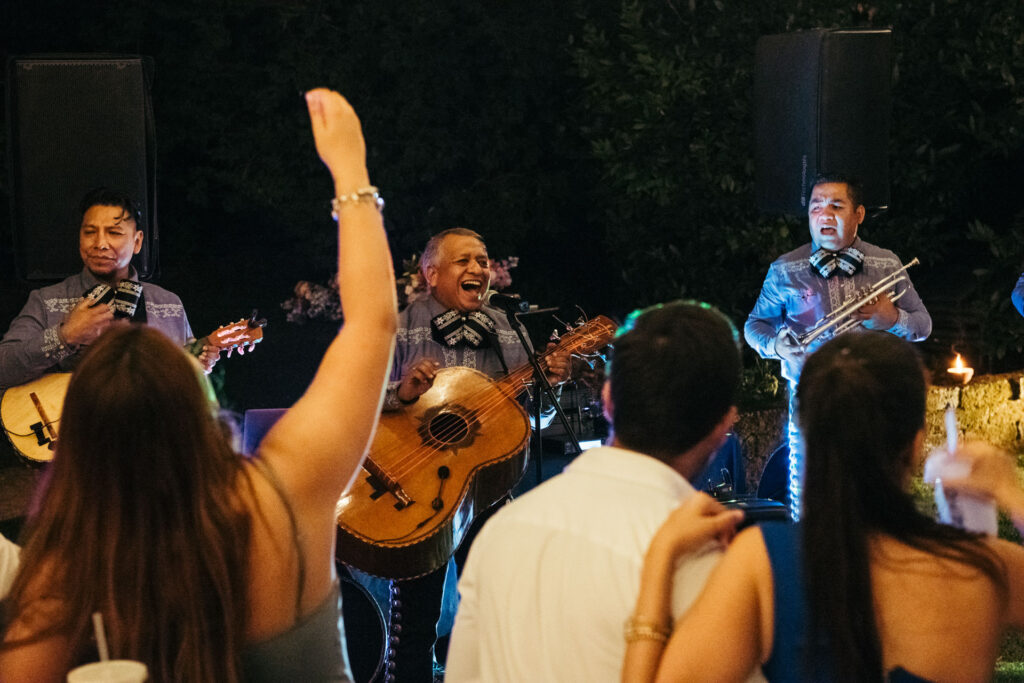 The Mariachi band serenades with heartfelt melodies, creating a magical and culturally rich ambiance with their expressive singing during the wedding celebration