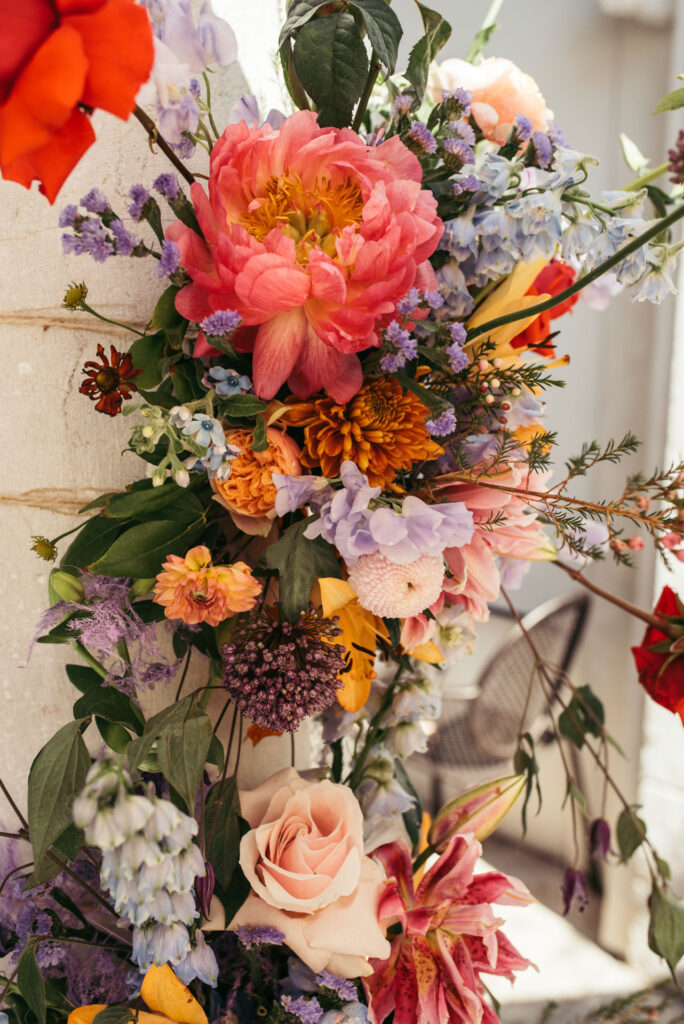 Lush and vibrant flower decorations create a lively and festive atmosphere, adding a kaleidoscope of hues to the wedding celebration