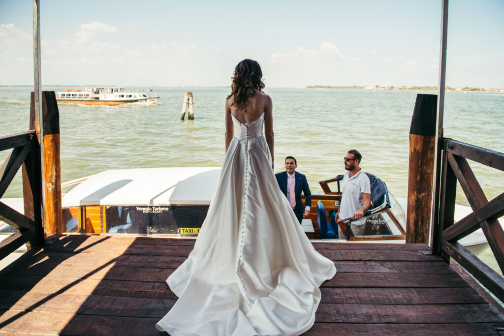 The bride and groom share a serene moment, gliding through the picturesque canals of Venice, anticipation building before their enchanting wedding ceremony