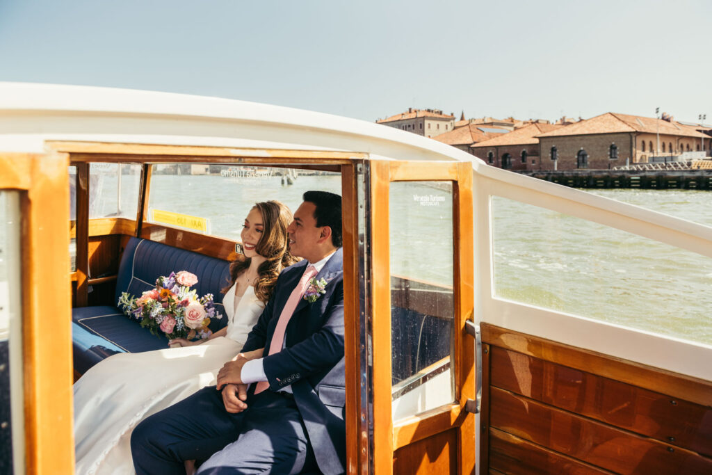 The bride and groom share a serene moment, gliding through the picturesque canals of Venice, anticipation building before their enchanting wedding ceremony