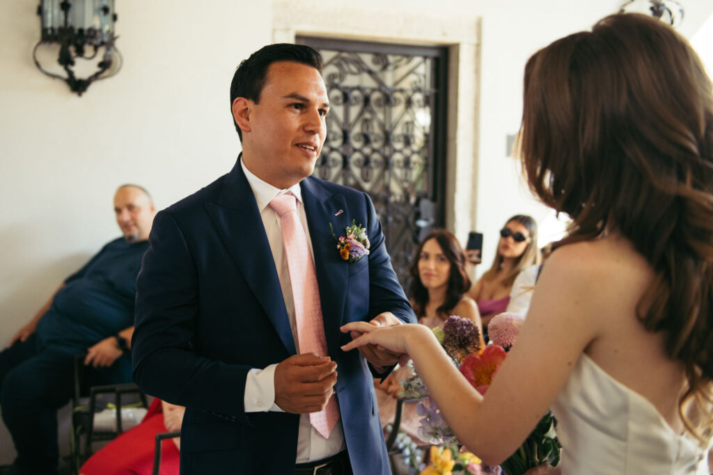 The bride and groom exchange rings at the wedding ceremony, sealing their commitment in a moment filled with love and the promise of a lifetime together