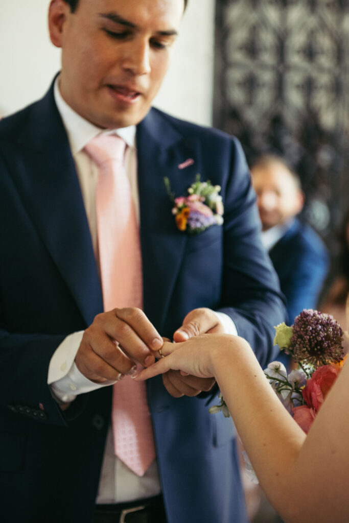 The bride and groom exchange rings at the wedding ceremony, sealing their commitment in a moment filled with love and the promise of a lifetime together