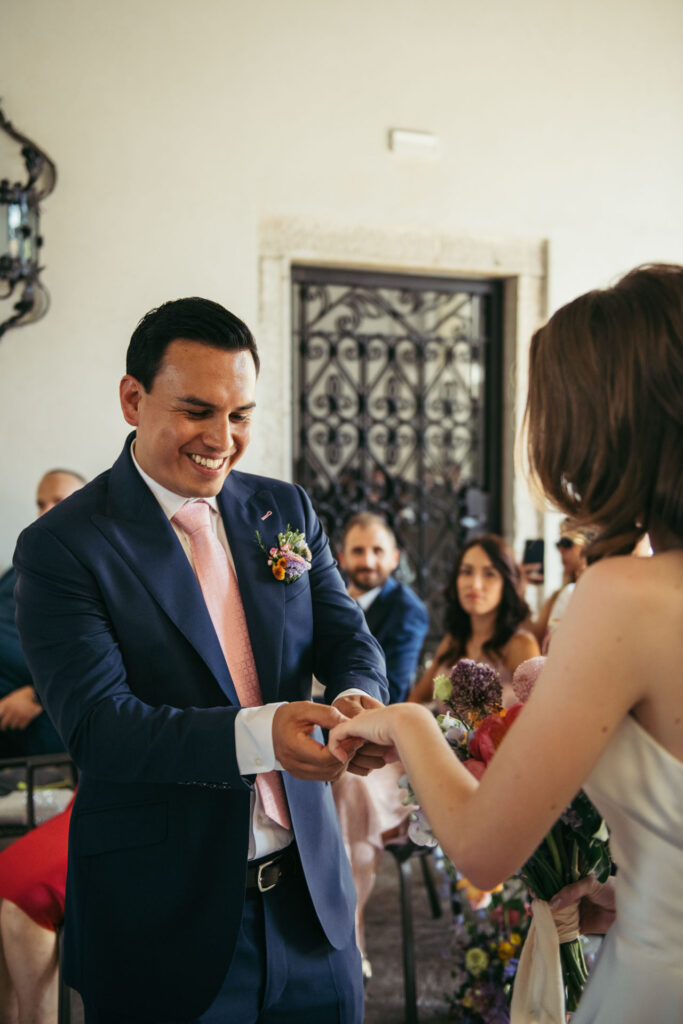 The bride and groom exchange rings at the wedding ceremony, sealing their commitment in a moment filled with love and the promise of a lifetime together