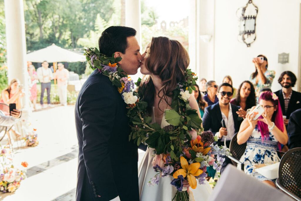 The bride and groom, adorned with the lazo, stand together in a moment symbolizing their eternal bond and shared commitment in marriage