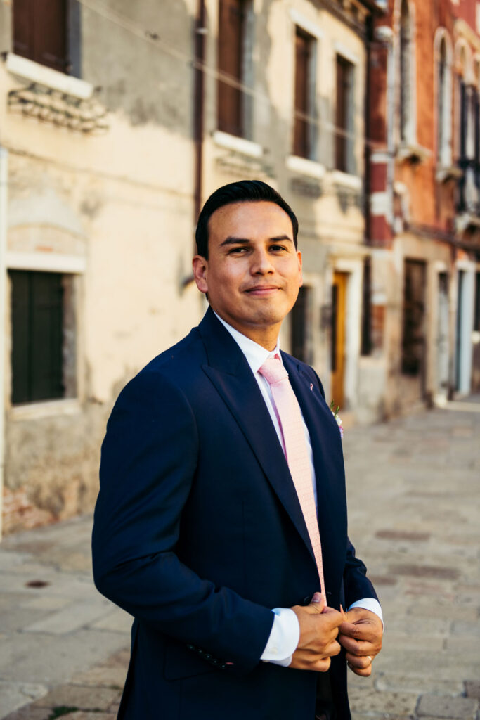 A charming portrait captures the groom's radiant smile against the backdrop of Venice