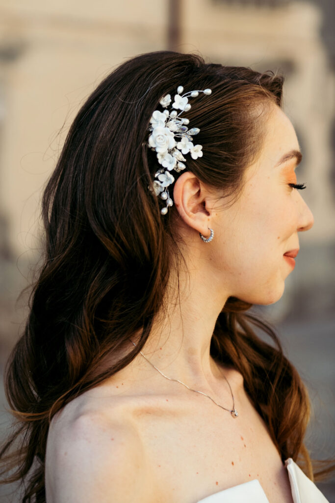 A close-up of the beautiful hair comb, adding a touch of elegance and sophistication to the bride's hairstyle in this intimate wedding detail