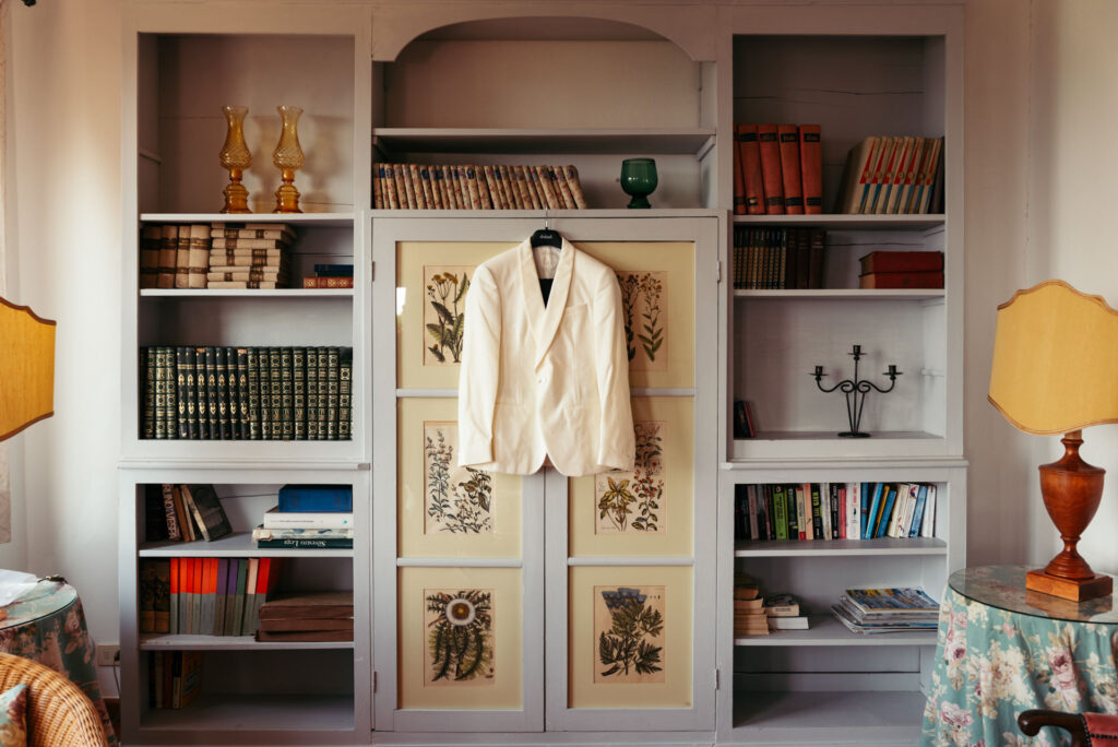 Groom jacket hanging on the wall before wedding day