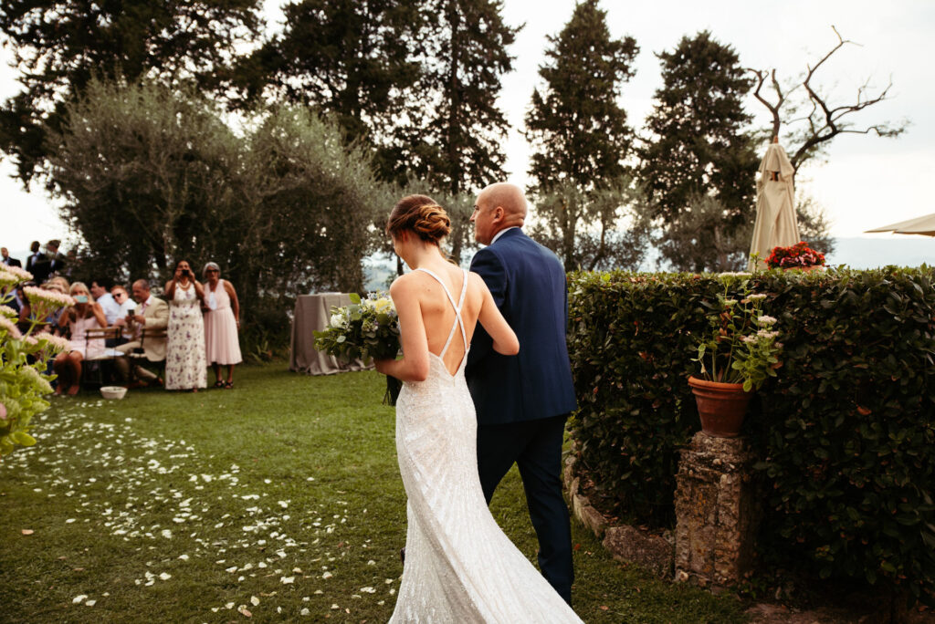 Bride arrives with her father and walks down the aisle