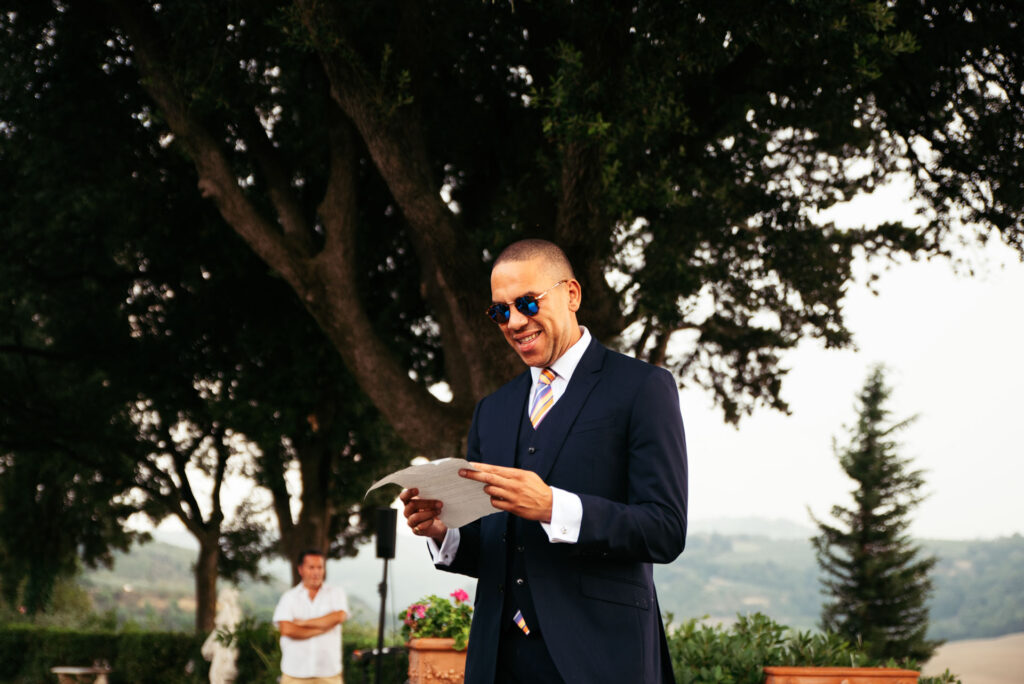 Groomsman reads a speech during the ceremony