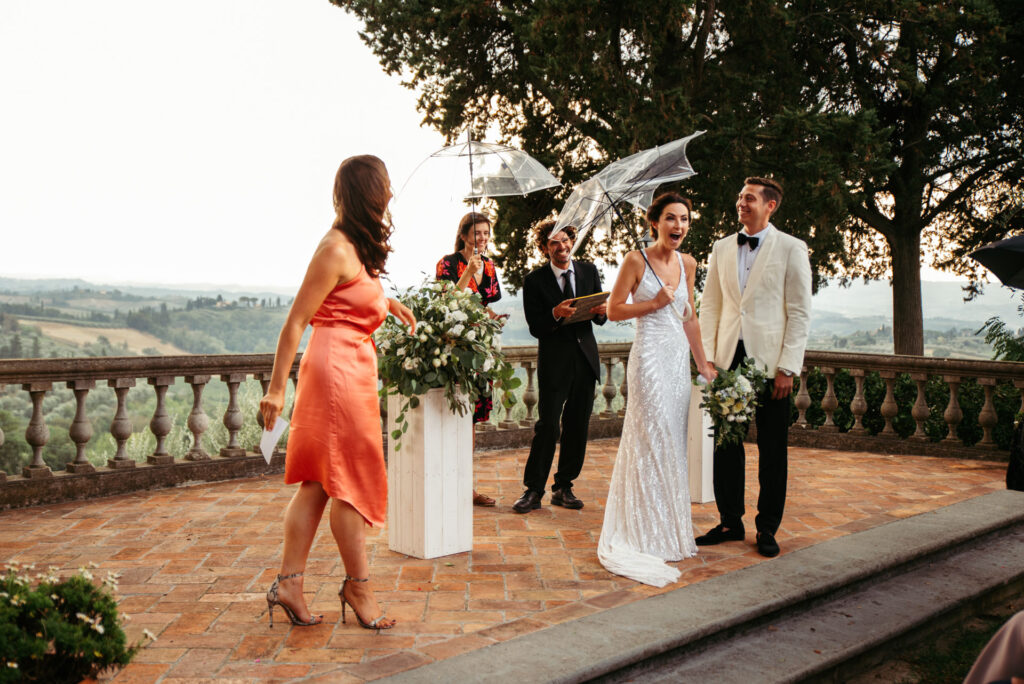 The wind is so strong that the umbrellas break during the ceremony