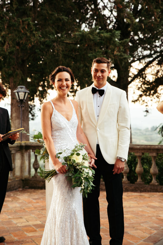 Bride and groom smile during the ceremony