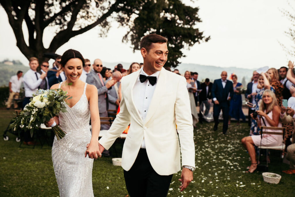 Bride and groom walk down the aisle after getting married