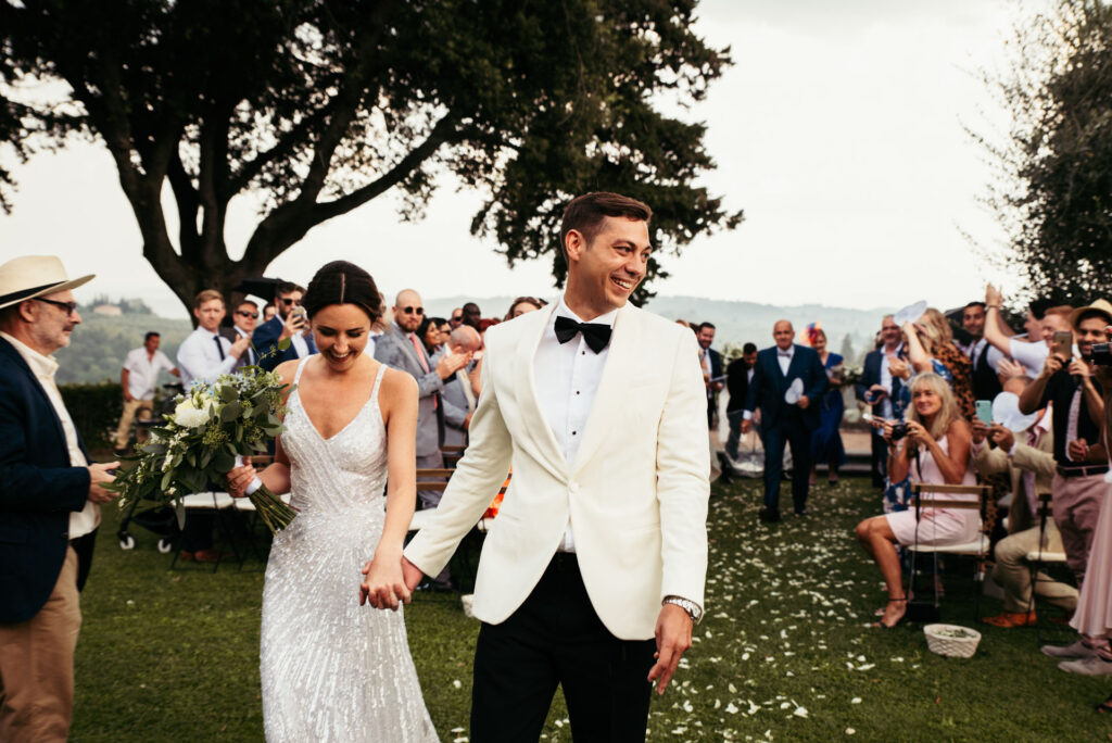 Bride and groom walk down the aisle after getting married