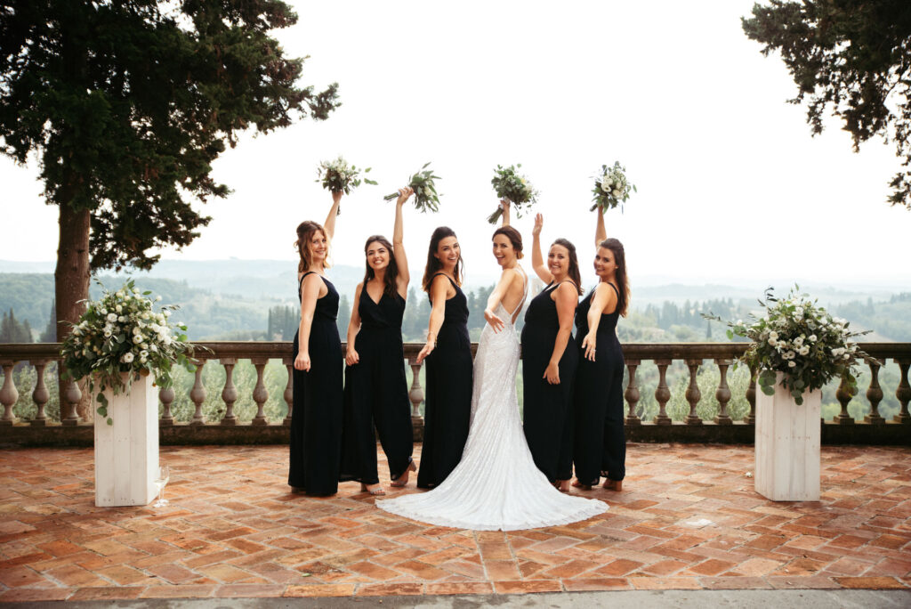 Photo of a bride and bridesmaid cheering with flowers