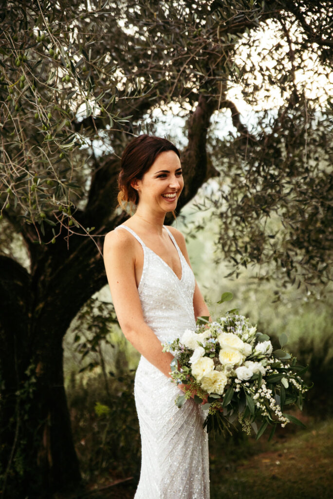 Portrait of bride posing between olives trees in Tuscany, Italy