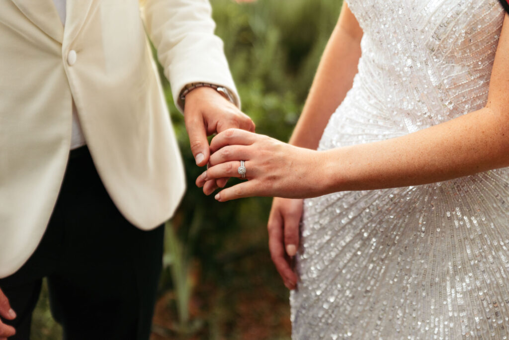 Bride and groom holding hands detail photo