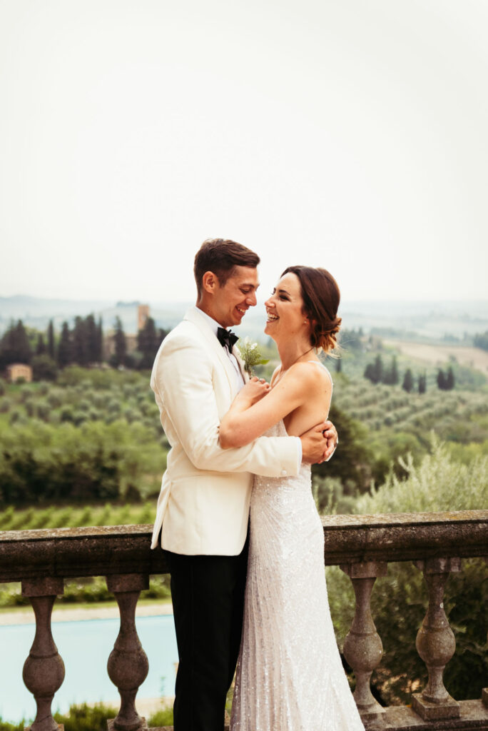 Newlyweds hugs against the picturesque backdrop of the Tuscan countryside, celebrating their marriage in Italy