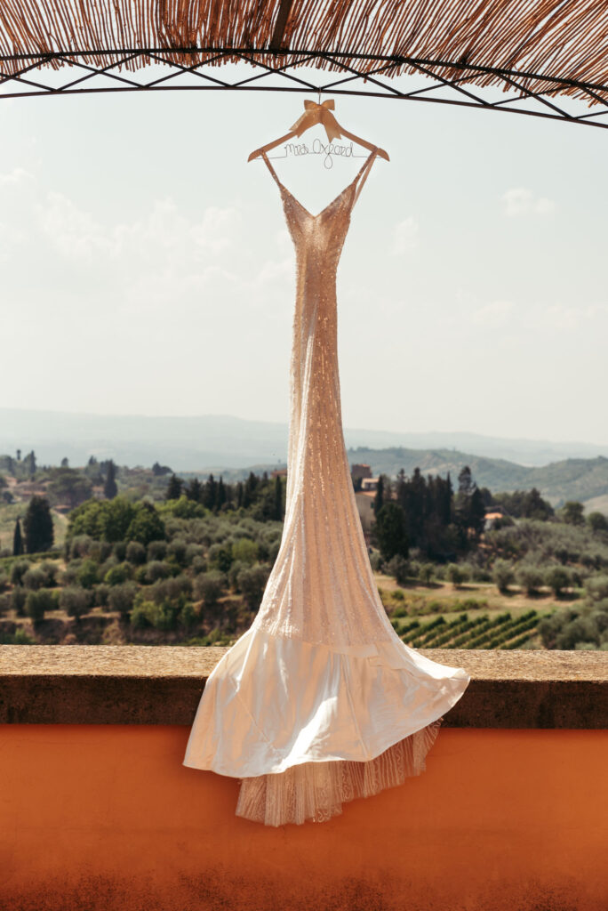 Bride's dress hanging with Tuscany hills on the background