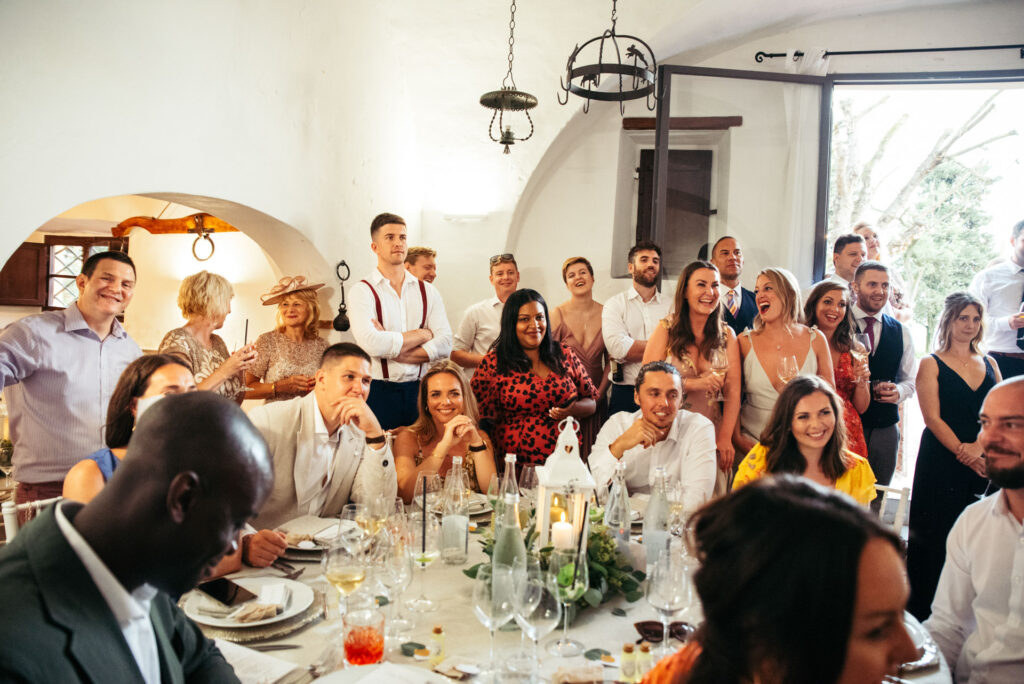 Wedding guests listening to the speeches at the villa