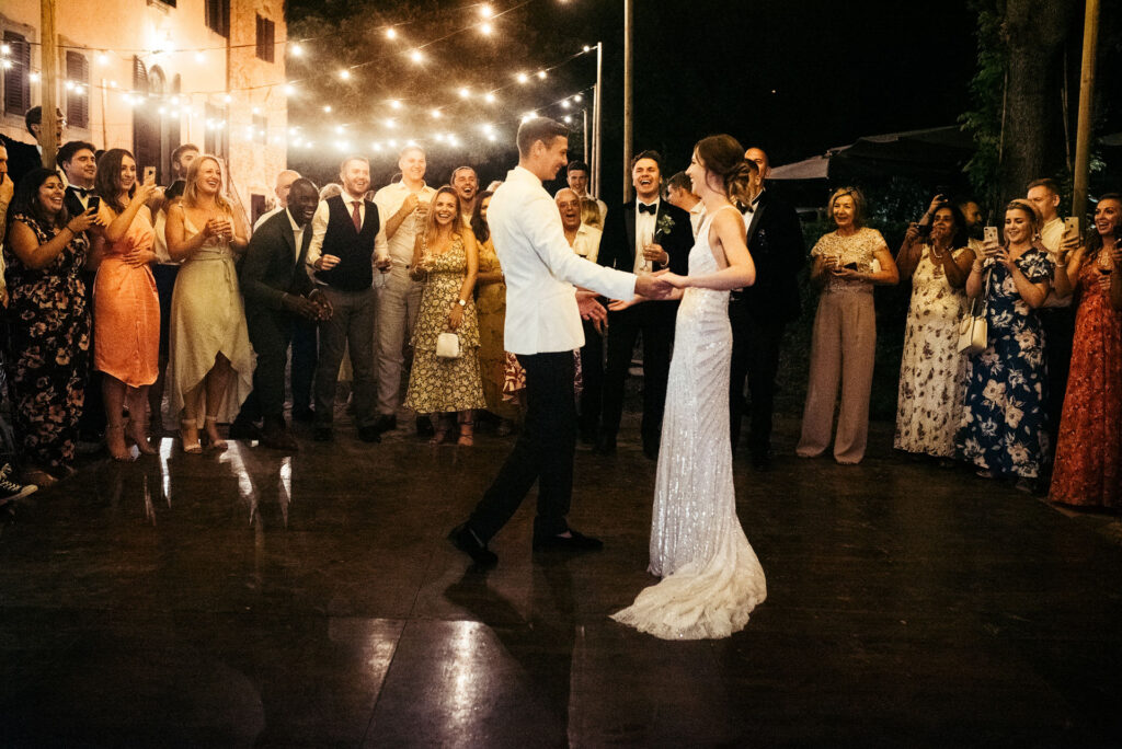 Bride and groom's first dance at their wedding day, while guests look at them