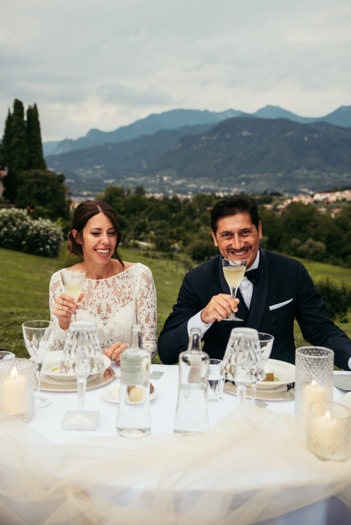 Bride and groom toasting during their intimate wedding in Lake Garda, Italy