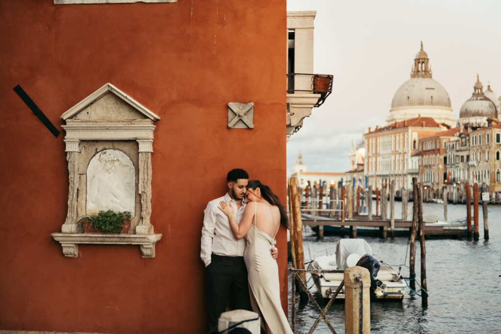 Couple hugging at sunset in Venice with Canal Grande on the background