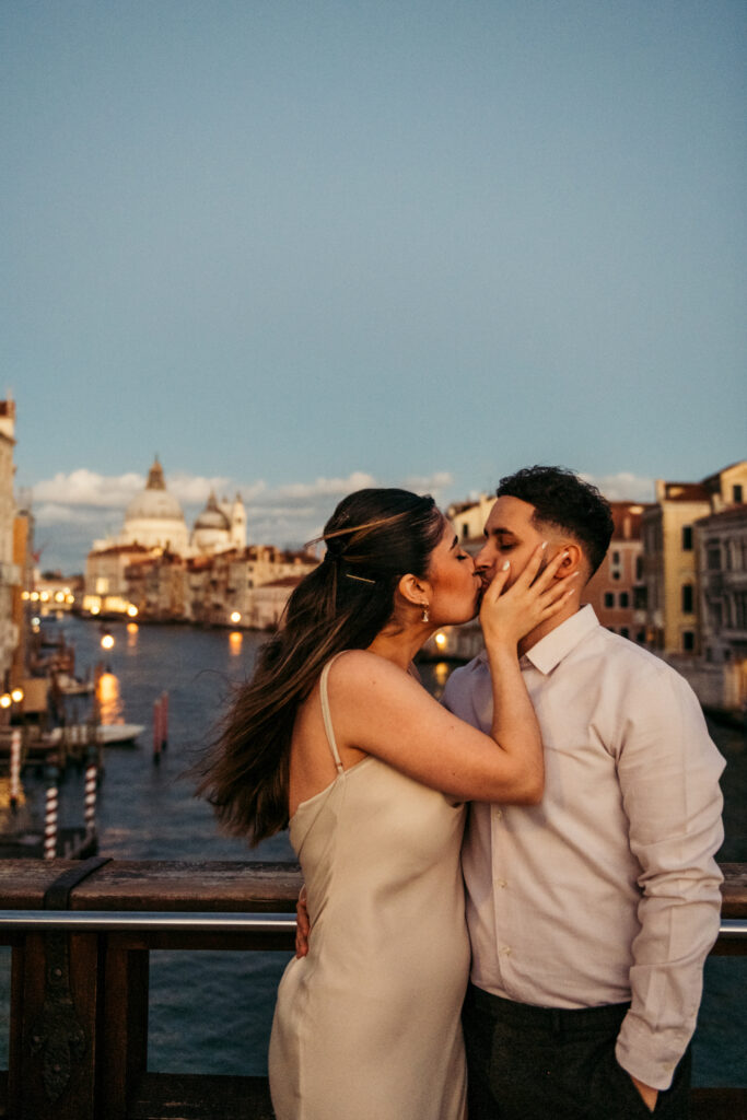 Couple kissing at dusk on Accademia bridge in Venice