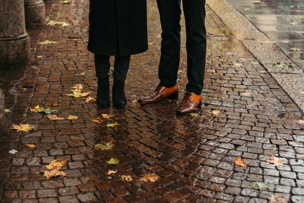 Couple's legs with autumn leaves on the floor