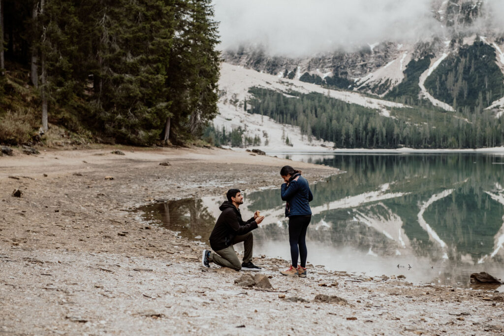 Man proposing to his girlfriend at Lake Braies in Dolomites, Italy