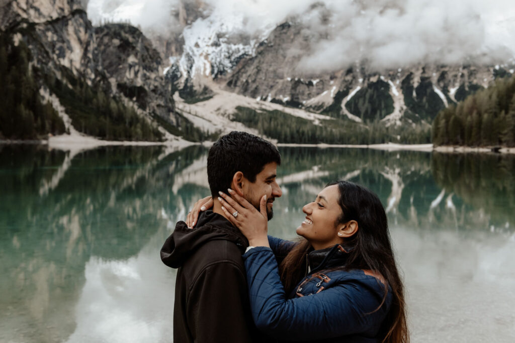 Couple close-up while smiling happily at Lake Braies in Italy