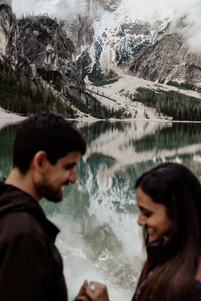 Lake Braies, Italy and couple looking at the ring blurred