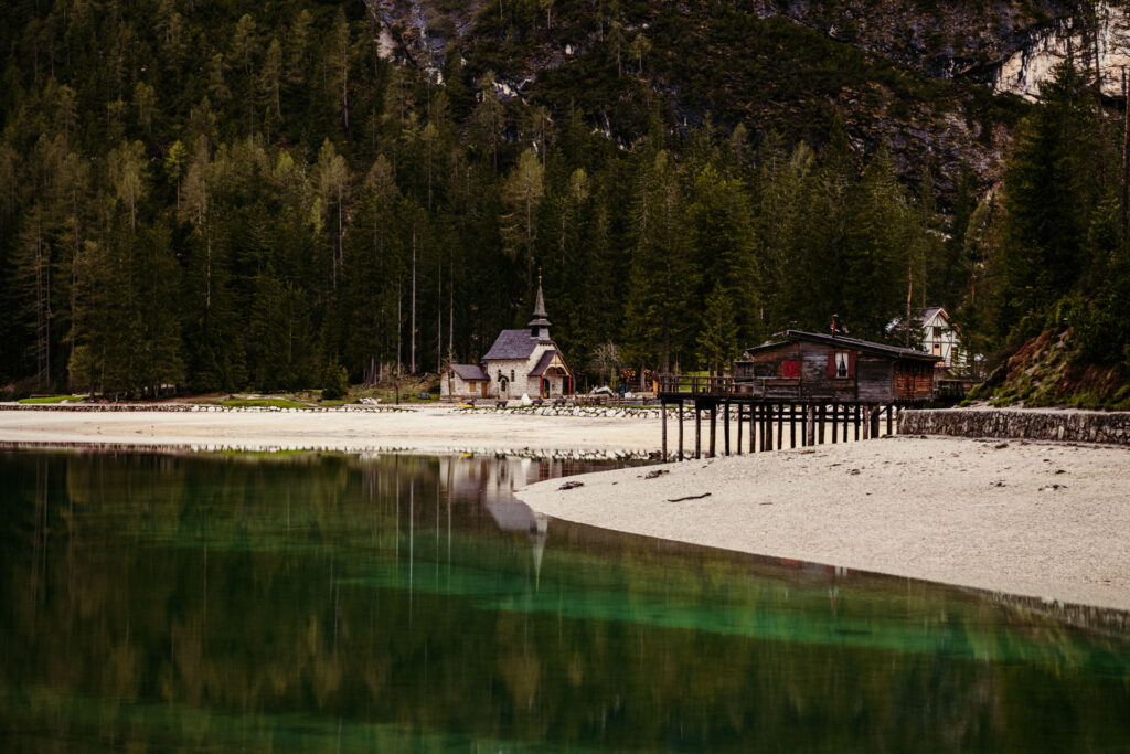 Horizontal panoramic photo of Lake Braies and its small church, Italy