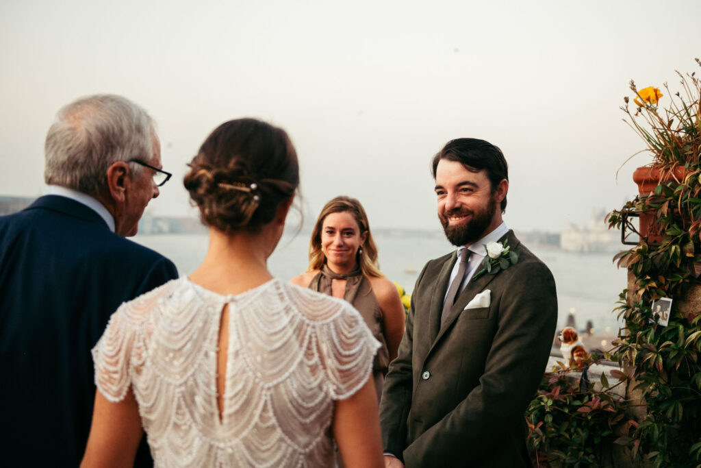 Groom smiles to the bride and her father