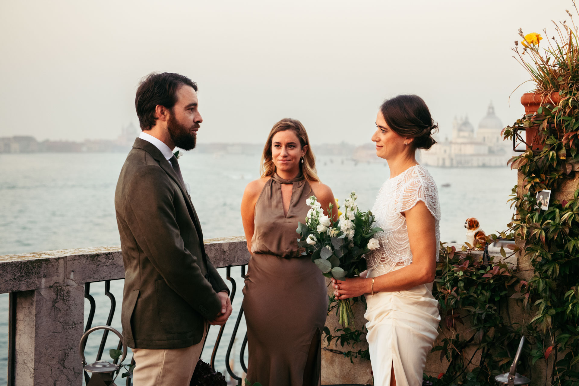 The groom and the bride are exchanging vows in front of the officiant