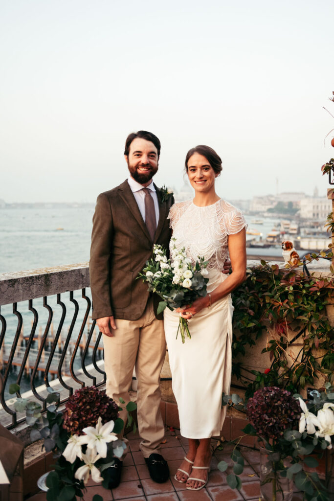 Portrait of the newly weds with Venice lagoon on the background