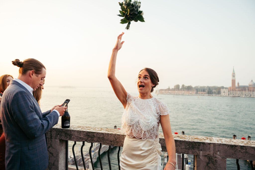 The bride throwing the bouquet down the balcony