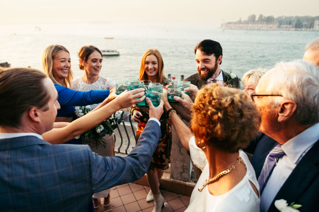 Guests making a toast with the bride and the groom