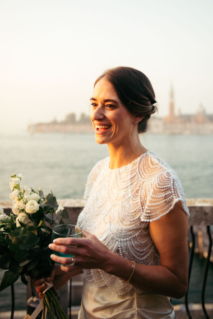 Bride smiling happily with a glass in her hand