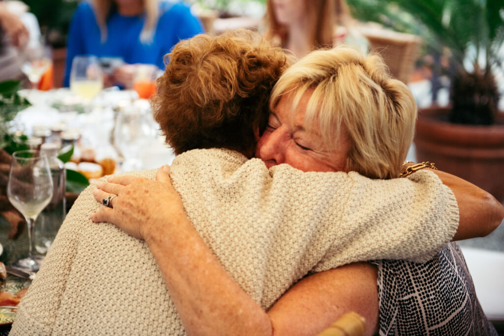 Bride's mum and groom's mum hug with happyness