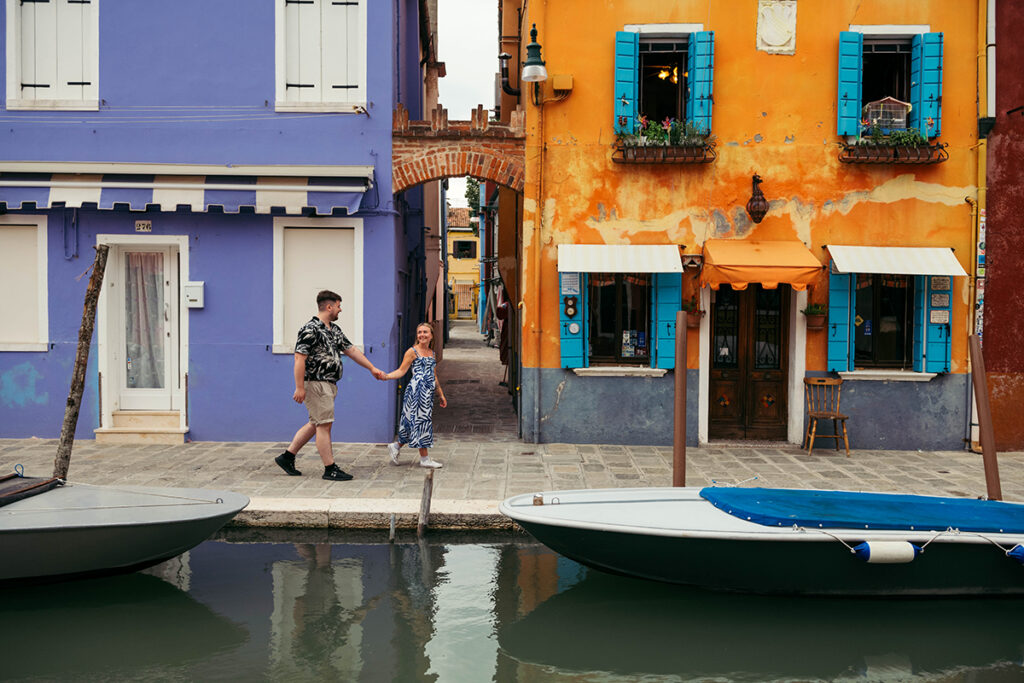 Couple walking in Burano island, one of the best photo spots in Venice