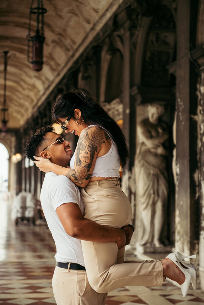 Couple laughing under the portico in San Marco square