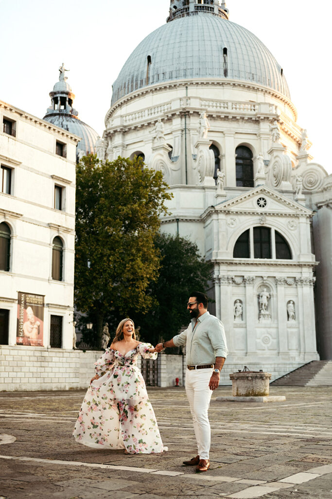 Couple dancing at sunset in front of Salute church in Venice, Italy