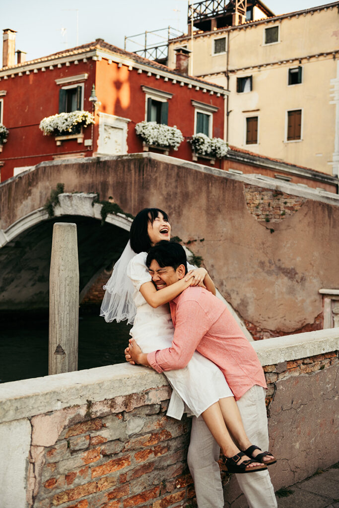 Couple laughing while having a fun pre-wedding photoshoot in Venice Italy