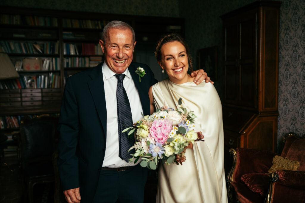 Bride and her dad smiling before the ceremony